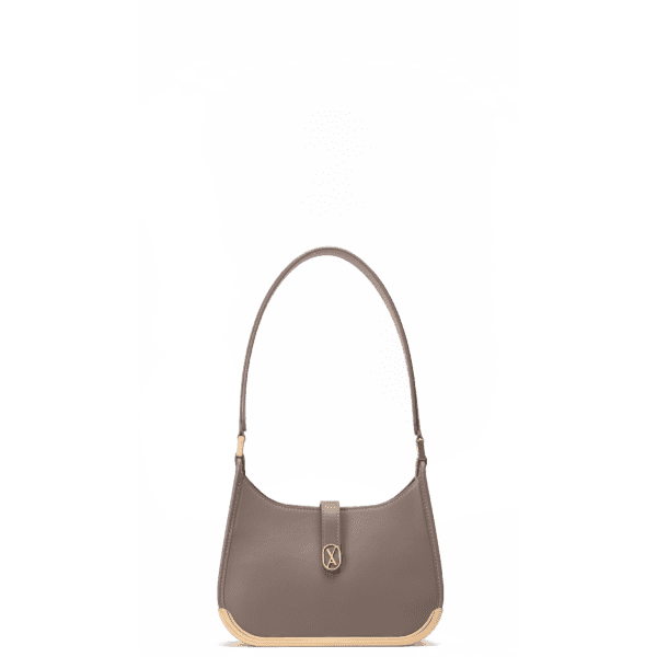 A small-sized taupe bag with a minimalistic design and curved edges. It has a golden metal frame on the bottom and a golden magnet with the Vaulie icon in the center. This luxury ICON bag, made in Italy, is ideal for an elegant woman.